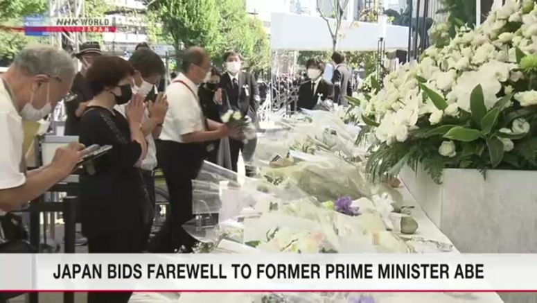 People in Japan place flowers on altars ahead of Abe's state funeral